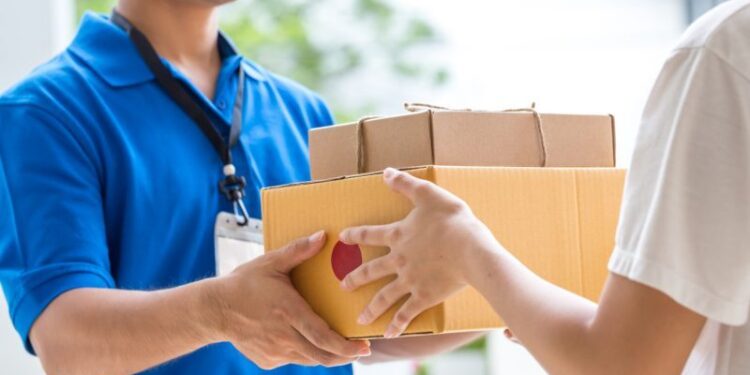 Woman hand accepting a delivery of boxes from deliveryman