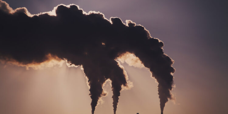 Air pollution clouds of smoke coming from the chimneys. Energy plantCombined heat and power