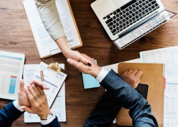 Business people shaking hands together