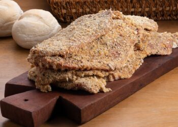 raw milaneses on wooden board