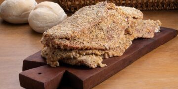 raw milaneses on wooden board