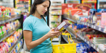 Woman checking food labelling